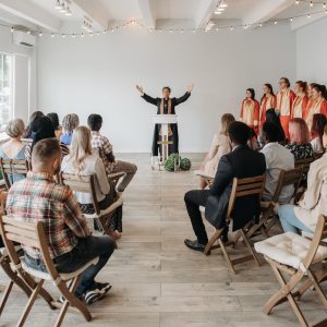 A diverse congregation gathers for a lively church service with choir and pastor.